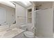 Cozy bathroom with glass shower, white toilet, and sink with vanity mirror at 27987 Pine Grove Trl, Conifer, CO 80433