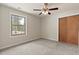 Bright bedroom features plush carpet, large closet, and window at 27987 Pine Grove Trl, Conifer, CO 80433