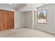 Clean bedroom with closet and view of the forest outside at 27987 Pine Grove Trl, Conifer, CO 80433