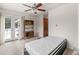 Bright bedroom features double doors, neutral carpet, and wooden ceiling fan with light fixture at 27987 Pine Grove Trl, Conifer, CO 80433
