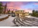 Two story home with winter sunset sky and snow covered driveway at 27987 Pine Grove Trl, Conifer, CO 80433