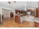 Open kitchen featuring stainless appliances, granite countertops, island cooktop, and view to living area at 27987 Pine Grove Trl, Conifer, CO 80433
