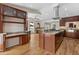 Open kitchen with granite countertops, stainless steel appliances, island cooktop, and wood floors at 27987 Pine Grove Trl, Conifer, CO 80433