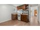 Kitchen with dark cabinets, tiled countertops, gas range, and light vinyl flooring at 27987 Pine Grove Trl, Conifer, CO 80433