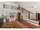 Spacious living room with staircase, hardwood floors, and views to the dining room at 27987 Pine Grove Trl, Conifer, CO 80433