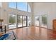 Bright living room featuring hardwood floors, large windows and sliding glass door offering abundant natural light at 27987 Pine Grove Trl, Conifer, CO 80433