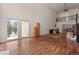 Open-concept living room with high ceilings, hardwood floors, and adjacent dining area at 27987 Pine Grove Trl, Conifer, CO 80433