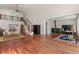 Bright living room with a staircase, wood-burning stove, and hardwood floors at 27987 Pine Grove Trl, Conifer, CO 80433