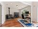 Comfortable office space featuring hardwood flooring, a rustic wood burning stove and large windows at 27987 Pine Grove Trl, Conifer, CO 80433
