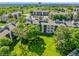 Aerial view of an apartment complex surrounded by mature trees and a green lawn, creating a peaceful setting at 8654 Decatur St # 251, Westminster, CO 80031