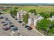 Apartment building featuring ample parking, mature trees, and landscaping for a well-maintained living environment at 8654 Decatur St # 251, Westminster, CO 80031