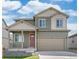 Charming two-story home featuring a covered porch, attached two car garage, and a landscaped front yard at 6525 14Th St, Frederick, CO 80530