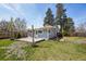 Backyard featuring a wooden deck, lush grass, and a partial fence at 4290 S Cherokee St, Englewood, CO 80110