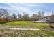 Exterior featuring wood deck, lush grass, and a partial fence at 4290 S Cherokee St, Englewood, CO 80110
