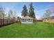 Spacious backyard with lush lawn, partial fencing and a deck at 4290 S Cherokee St, Englewood, CO 80110