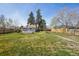 Backyard featuring a wooden deck, green lawn, and partial fencing at 4290 S Cherokee St, Englewood, CO 80110