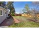 Spacious backyard featuring a brick patio, lush lawn and a wooden fence for privacy at 4290 S Cherokee St, Englewood, CO 80110