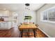 Sunlit dining room with wooden table, woven chairs, and modern light fixture at 4290 S Cherokee St, Englewood, CO 80110