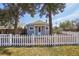 Charming home with a white picket fence and mature trees in a serene setting at 4290 S Cherokee St, Englewood, CO 80110