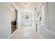 Bright hallway with light blue walls, white trim, tiled floor and stylish accents at 4290 S Cherokee St, Englewood, CO 80110