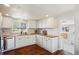 Updated kitchen with white cabinets, butcher block counters, and modern fixtures at 4290 S Cherokee St, Englewood, CO 80110
