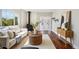 Cozy living room with a fireplace, wood floors, and ample natural light at 4290 S Cherokee St, Englewood, CO 80110