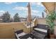 Outdoor balcony offering seating and a small table, perfect for relaxation at 1818 S Quebec Way # 11-3, Denver, CO 80231