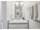 Well-lit bathroom vanity with marble countertop and modern fixtures at 1818 S Quebec Way # 11-3, Denver, CO 80231