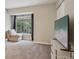 Bedroom featuring a cozy chaise lounge by the window and a modern television at 1818 S Quebec Way # 11-3, Denver, CO 80231