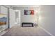 Spacious carpeted bedroom with a comfortable bench and modern decor at 1818 S Quebec Way # 11-3, Denver, CO 80231