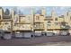 A view of the townhome exterior featuring individual balconies and attached garages for each unit at 1818 S Quebec Way # 11-3, Denver, CO 80231