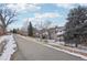 Townhouses with snowy path and trees alongside at 1818 S Quebec Way # 11-3, Denver, CO 80231