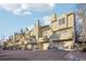 Attached townhouses with garages and private balconies, set against a bright sky at 1818 S Quebec Way # 11-3, Denver, CO 80231