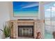 Modern fireplace with brick surround and a television hanging above at 1818 S Quebec Way # 11-3, Denver, CO 80231