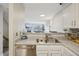 Bright kitchen view overlooking the living room, showing the sink, dishwasher, and decor at 1818 S Quebec Way # 11-3, Denver, CO 80231