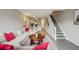 Open-concept living room with hardwood floors, couch, stairs and view into the kitchen at 1818 S Quebec Way # 11-3, Denver, CO 80231