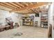 Unfinished basement with exposed beams, shelves, and concrete flooring for ample storage at 23039 Isoleta Rd, Indian Hills, CO 80454