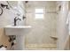 Inviting pedestal sink bathroom and shower with custom tile, and great lighting at 23039 Isoleta Rd, Indian Hills, CO 80454