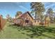 A charming wood sided house with a fenced in yard and well-maintained lawn at 23039 Isoleta Rd, Indian Hills, CO 80454