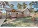 Inviting home with log siding, a decorative well, and a cozy front porch with flower boxes at 23039 Isoleta Rd, Indian Hills, CO 80454