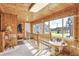 Hallway with wood paneling, large windows, and a view of the outdoor scenery at 23039 Isoleta Rd, Indian Hills, CO 80454