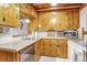 Kitchen with wooden cabinets, stainless steel appliances, and an undermount sink at 23039 Isoleta Rd, Indian Hills, CO 80454
