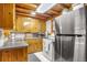 Kitchen featuring wooden cabinets, stainless steel appliances, and tile flooring at 23039 Isoleta Rd, Indian Hills, CO 80454