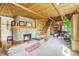 Cozy living room featuring a fireplace, wooden walls, and stairs leading to the upper level at 23039 Isoleta Rd, Indian Hills, CO 80454