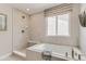Bright bathroom featuring a soaking tub, tiled shower, and modern fixtures at 13333 Blue Amber Ct, Parker, CO 80134