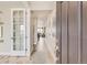 Inviting entryway featuring light wood floors, neutral walls, and stylish decor leading into a modern home at 13333 Blue Amber Ct, Parker, CO 80134