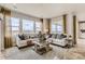Spacious living room with large windows offering picturesque views, stylish decor, and comfortable seating at 13333 Blue Amber Ct, Parker, CO 80134