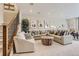 Spacious living room features a large sectional sofa, modern decor, and a staircase to the upper level at 13333 Blue Amber Ct, Parker, CO 80134