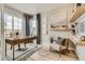 Bright home office with a stylish desk, comfortable chair, and natural light from a large window at 13333 Blue Amber Ct, Parker, CO 80134