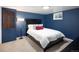 Basement bedroom with a black bed frame, blue walls, and carpet at 1852 S Elm St, Denver, CO 80222